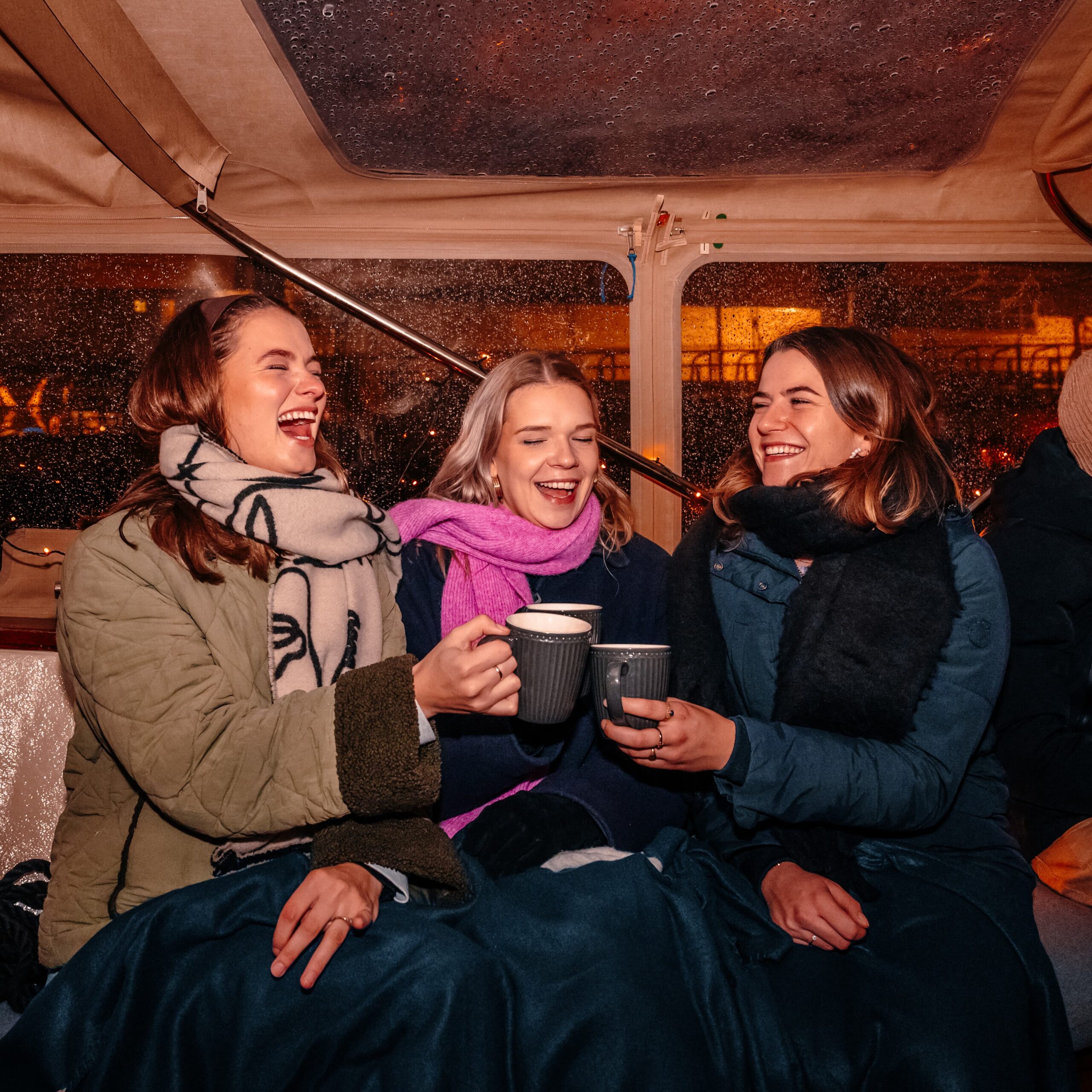 People enjoying the amsterdam light festival from a boat