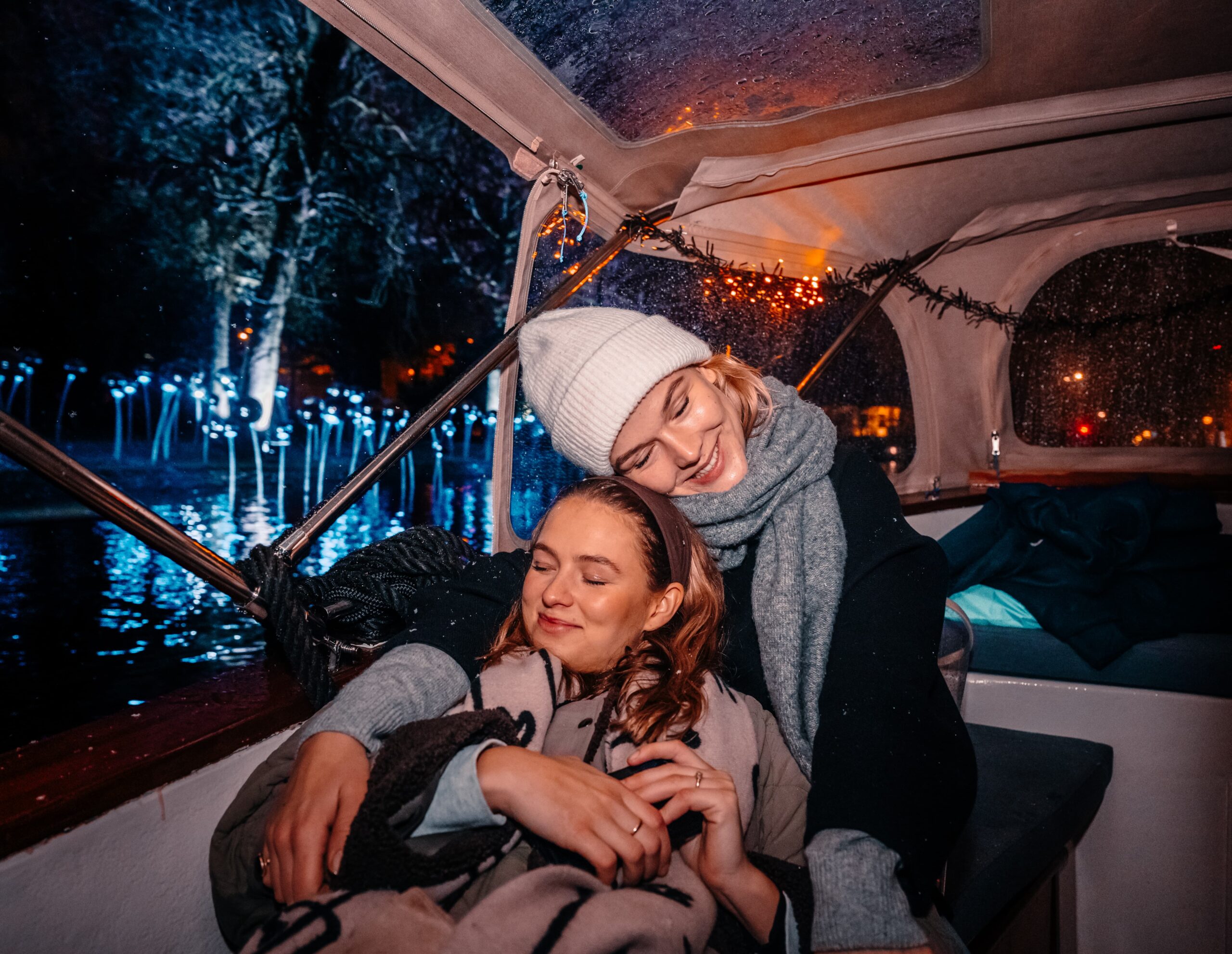 People enjoying the amsterdam light festival from a boat